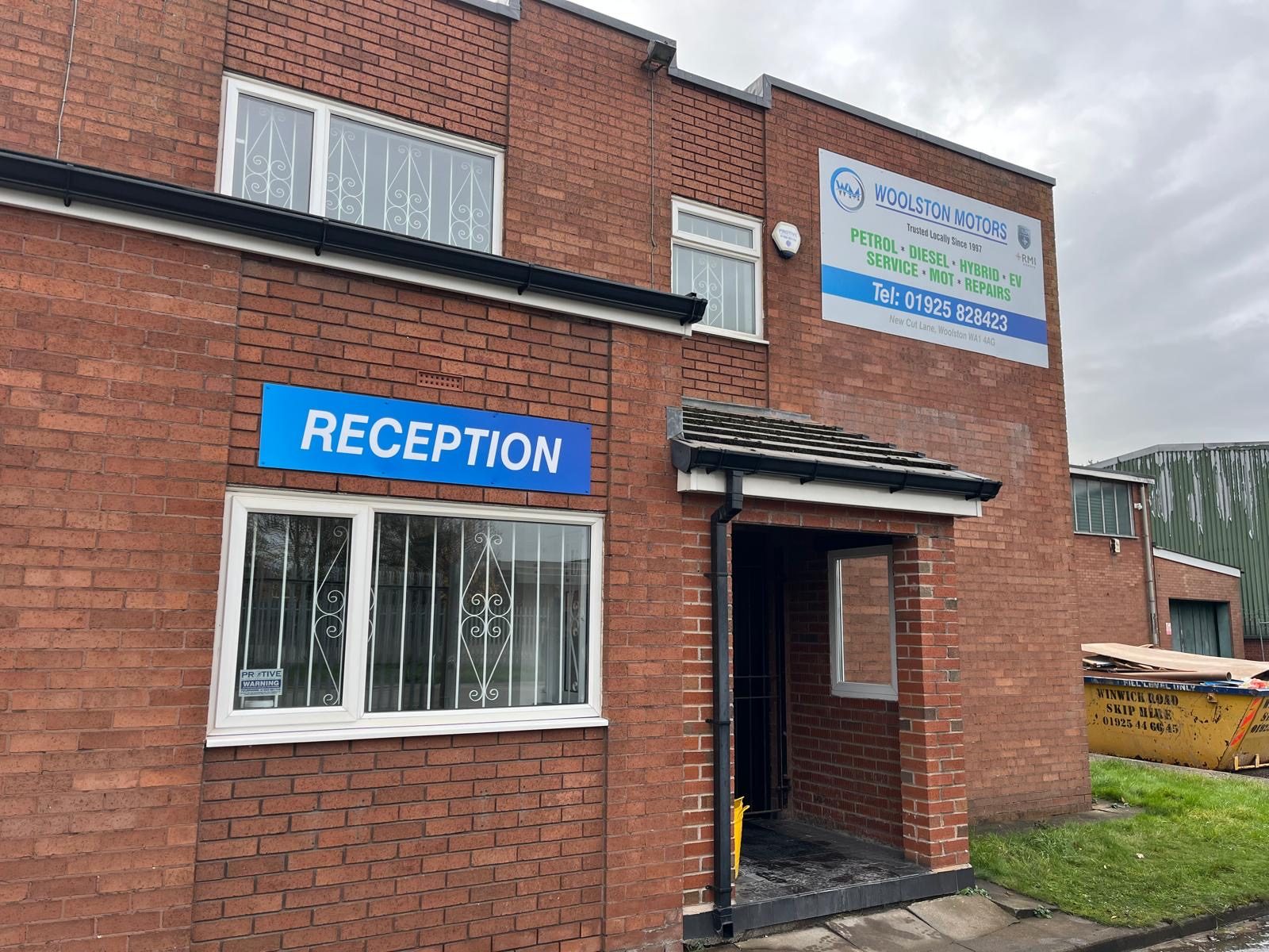 The reception entrance and Woolston Motors sign at 5 New Cut Lane